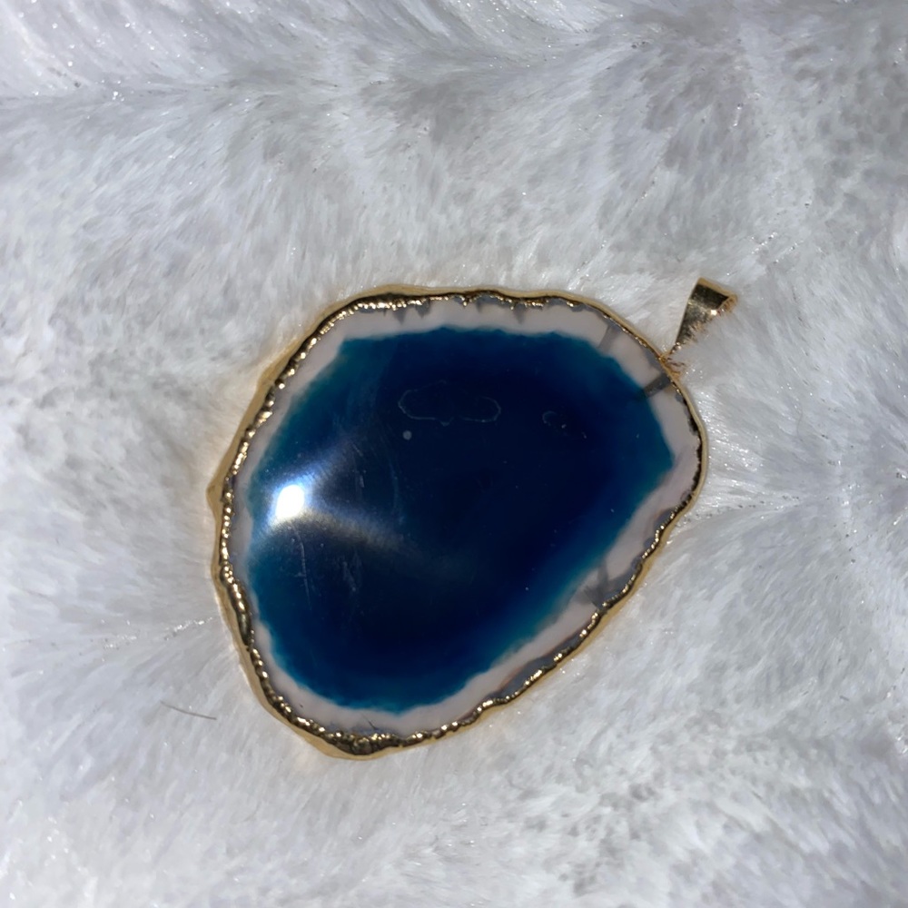 Sliced agate with gold pendants.